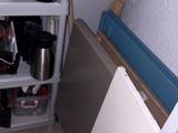 a white toilet sitting in a bathroom next to a cabinet
