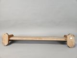 a wooden bench that is sitting on a gray surface