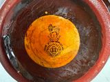 an orange that is sitting in a bowl on the table