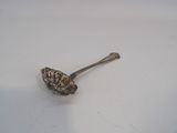 a spoon that is sitting on a white surface