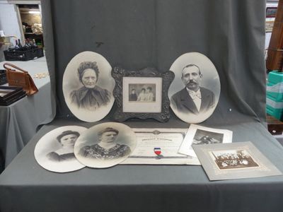 a table that has a bunch of old photos on it