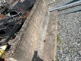 a pile of junk on the ground next to a train track