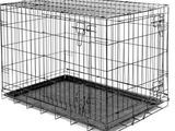 une cage pour chien en métal noir dont la porte est ouverte
