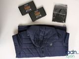 a blue jacket, a pair of socks, and a box of tissues sitting on a table