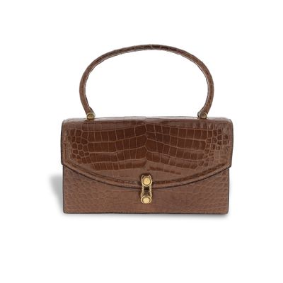 a brown crocodile skin handbag on a white background