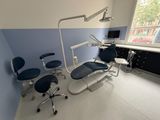 a dentist ' s office with chairs and a desk