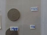 a lot of different coins on display in a glass case