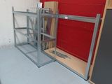 a metal shelf that is next to a red wall