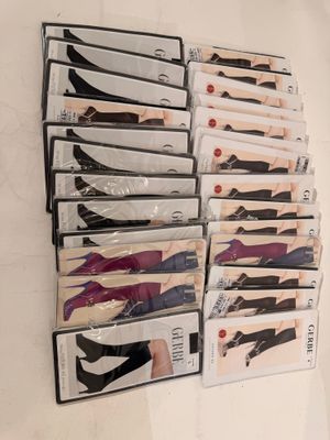 several pairs of women ' s stockings are stacked on top of each other