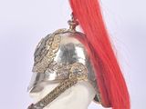 a silver helmet with red hair on a mannequin head