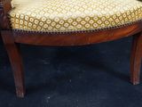 an image of a wooden chair with a yellow and white upholstered seat