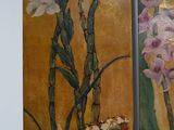 two paintings of flowers in a vase on the wall