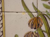 a close up of a tile with flowers on it