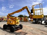 a yellow crane that is sitting in a parking lot