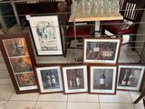 many framed pictures of wine bottles and bottles on the table