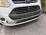 the front end of a white ford transit van parked in a parking lot