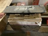 a person holding a box full of papers on a pallet