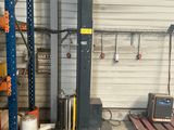 a picture of a forklift in a warehouse with pallets in the background
