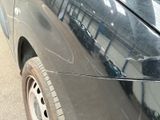 a close up of a car ' s front bumper with scratches on it