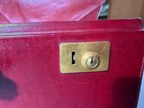 a red purse that has a gold lock on it