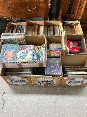 many boxes of books stacked on top of each other on the floor