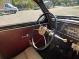a steering wheel and dashboard of a car in a parking lot