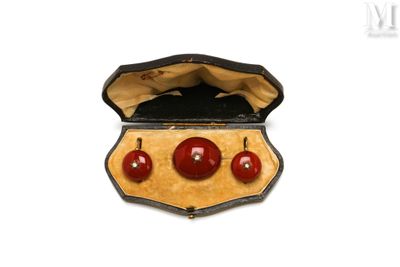 three red balls in a case on a white surface