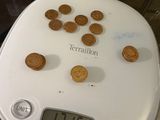 a digital scale with cookies on it on a table