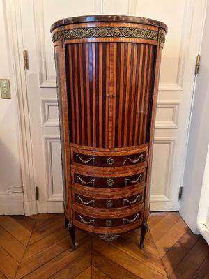 a tall wooden cabinet in the corner of a room