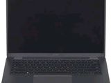 un ordinateur portable ouvert posé sur une surface blanche