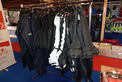 un grand nombre de vestes suspendues à un présentoir dans un magasin