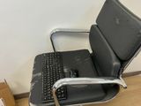 a black leather office chair with a laptop on it