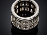 a close up of a diamond ring on a black surface
