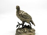figurine en bronze représentant un oiseau perché sur une branche