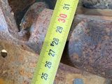 a measuring tape that is on the side of a piece of metal