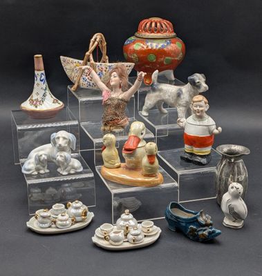 a lot of figurines that are sitting on a shelf