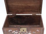 a small wooden box with a floral design on it