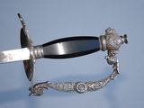 a silver sword with a black handle on a blue background