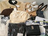 a pile of clothes and shoes on a table