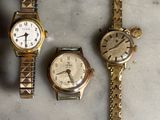 trois montres sont assises l'une à côté de l'autre sur une table