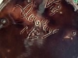 a chocolate cake with writing on it sitting on a table