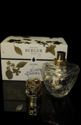 an image of a bottle of perfume next to a box on a table
