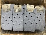 three pairs of men ' s socks in a box on a plastic wrapper