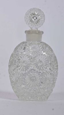 a clear glass bottle with a lid on a white surface