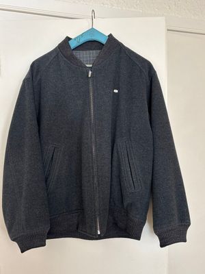 the jacket is hanging on the wall next to the door