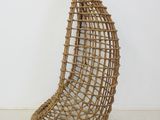 pair of wicker hanging chairs in the shape of a boat