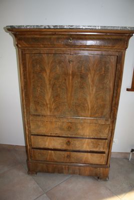 a wooden cabinet with a marble top in a room