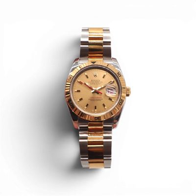 a close up of a watch on a white surface with a white background
