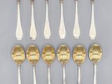 a set of twelve silver and gold spoons