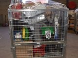 a metal cart with many items in it in a warehouse